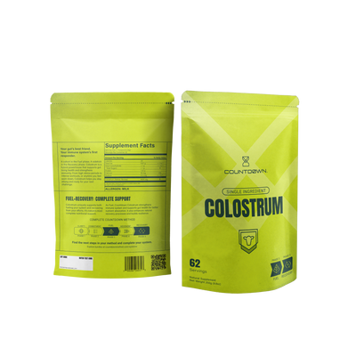 Two green packages of Countdown Colostrum on a white background